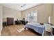 Comfortable bedroom with wood-style flooring, white ceiling fan, shutters, dresser, and desk creates a welcoming retreat at 1738 W Yosemite Pl, Chandler, AZ 85248