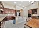 Well-appointed kitchen featuring granite countertops, dark cabinetry, and modern appliances at 1738 W Yosemite Pl, Chandler, AZ 85248