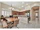 Bright kitchen featuring granite countertops, dark cabinetry, and an adjacent dining area at 1738 W Yosemite Pl, Chandler, AZ 85248