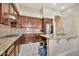 Well-equipped kitchen with granite countertops, dark wood cabinetry, and a breakfast bar at 1738 W Yosemite Pl, Chandler, AZ 85248