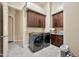 Well-equipped laundry room features modern washer/dryer, tile floor, and ample cabinet storage for efficient chores at 1738 W Yosemite Pl, Chandler, AZ 85248