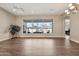 Large living room featuring wood flooring, a ceiling fan, and views of the outdoor pool at 1738 W Yosemite Pl, Chandler, AZ 85248