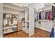 Walk-in closet featuring custom shelving, hanging rods, and hardwood flooring at 1738 W Yosemite Pl, Chandler, AZ 85248