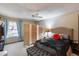 Bedroom with paneled folding screen, patterned curtains, ceiling fan, and upholstered bench at 17428 N Boswell Blvd, Sun City, AZ 85373