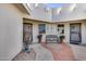 Charming courtyard entrance with potted plants, stylish bench, and a welcoming ambiance to this lovely home at 17428 N Boswell Blvd, Sun City, AZ 85373