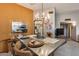 Dining area with a rustic table, chandelier lighting, and adjacent living room views at 17428 N Boswell Blvd, Sun City, AZ 85373