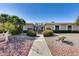 Charming single-story home with a well-maintained xeriscaped front yard and pathway to a gated entrance at 17428 N Boswell Blvd, Sun City, AZ 85373