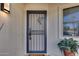 A decorative black security screen door enhances this home's curb appeal and provides added security at 17428 N Boswell Blvd, Sun City, AZ 85373