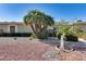 Well-kept front yard with desert landscaping, mature palm trees, and an ornamental sculpture at 17428 N Boswell Blvd, Sun City, AZ 85373