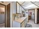 Functional kitchen layout with white cabinetry, countertops, and easy access to adjacent areas at 17428 N Boswell Blvd, Sun City, AZ 85373