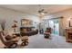 Inviting living room with plush seating, neutral carpet, ceiling fan and sliding glass doors to the patio at 17428 N Boswell Blvd, Sun City, AZ 85373