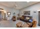 Spacious living room featuring a ceiling fan, a large sofa, and a comfortable armchair at 17428 N Boswell Blvd, Sun City, AZ 85373