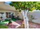 Relaxing outdoor patio with brick flooring, painted tree, and comfortable seating at 17428 N Boswell Blvd, Sun City, AZ 85373