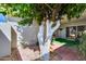 Outdoor patio featuring painted tree, brick flooring, grass rug, and comfortable seating at 17428 N Boswell Blvd, Sun City, AZ 85373