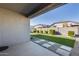 Backyard featuring artificial turf, a gravel bed, stepping stones, and a tall block fence at 17580 W Country Club Ter, Surprise, AZ 85387