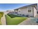 Low maintenance backyard with artificial turf and gravel landscaping at 17580 W Country Club Ter, Surprise, AZ 85387