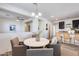 Bright dining area featuring a modern chandelier and views into the kitchen and living spaces at 17580 W Country Club Ter, Surprise, AZ 85387