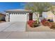 Charming single-story home with well-maintained landscaping and an attached two-car garage at 17580 W Country Club Ter, Surprise, AZ 85387