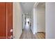 Open hallway leading into the home, featuring wood-look floors and neutral-colored walls at 17580 W Country Club Ter, Surprise, AZ 85387