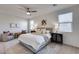 Cozy main bedroom with comfortable furniture, lamps, artwork, and natural light at 17580 W Country Club Ter, Surprise, AZ 85387