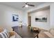 Office space featuring a dark wood table, neutral decor, and blue abstract art on the walls at 17580 W Country Club Ter, Surprise, AZ 85387