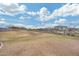 Community field featuring walking paths and native desert landscaping with neighborhood homes in the distance at 17580 W Country Club Ter, Surprise, AZ 85387