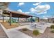 Community area with a shaded playground, picnic tables, and bench seating for gatherings at 17580 W Country Club Ter, Surprise, AZ 85387