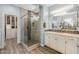 Bright bathroom featuring a glass shower, white vanity, quartz countertop, and walk-in closet at 18068 E Curva De Plata --, Rio Verde, AZ 85263