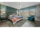 Bright bedroom featuring a large bed, teal accents, ceiling fan, and natural light at 18068 E Curva De Plata --, Rio Verde, AZ 85263