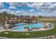 This community pool features lounge chairs, palm trees, shade structures, and mountain views at 18068 E Curva De Plata --, Rio Verde, AZ 85263