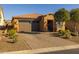 Charming home featuring a two-car garage, neutral colors, and low maintenance desert landscaping at 18068 E Curva De Plata --, Rio Verde, AZ 85263