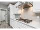 White kitchen with stainless steel appliances, marble countertops, and sleek backsplash at 18068 E Curva De Plata --, Rio Verde, AZ 85263