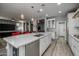 Open white kitchen with marble countertops, stainless steel appliances, and breakfast bar at 18068 E Curva De Plata --, Rio Verde, AZ 85263