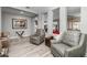 Open living room area with gray accent chairs, wood-look flooring, and neutral walls at 18068 E Curva De Plata --, Rio Verde, AZ 85263