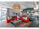 Vibrant living space with a large red sectional, unique light fixture and view to kitchen at 18068 E Curva De Plata --, Rio Verde, AZ 85263