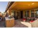 The covered patio includes a built-in grill, tiled floors, and comfortable seating areas at 18068 E Curva De Plata --, Rio Verde, AZ 85263