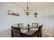 Dining room featuring a modern table, four chairs, and stylish decorative lighting at 18624 N 92Nd Dr, Peoria, AZ 85382