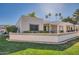 Exterior home view with a charming patio overlooking a lush lawn at 18624 N 92Nd Dr, Peoria, AZ 85382