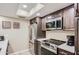 Modern kitchen featuring stainless steel appliances and recessed lighting illuminating the counter tops at 18624 N 92Nd Dr, Peoria, AZ 85382