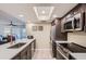 Modern kitchen featuring sleek countertops, stainless steel appliances, and ample natural light at 18624 N 92Nd Dr, Peoria, AZ 85382