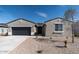 Charming single-story home featuring a low maintenance desert rock yard and a two car garage at 18743 N Avelino Dr, Maricopa, AZ 85138