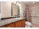 Well-lit bathroom with a granite vanity, brushed nickel faucet, and tiled shower at 19214 N 31St Dr, Phoenix, AZ 85027