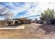 Expansive backyard with gravel, concrete pad, and a covered patio, offering great potential for outdoor living at 200 E Rose Ln, Avondale, AZ 85323