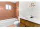 Bathroom with a white toilet, tiled walls, and sink at 200 E Rose Ln, Avondale, AZ 85323