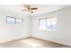 Bedroom features two windows, white walls, and ceiling fan at 200 E Rose Ln, Avondale, AZ 85323