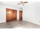 Bedroom with white walls, closet, and ceiling fan at 200 E Rose Ln, Avondale, AZ 85323