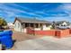 Single-story home with a quaint yard, featuring a painted block wall and convenient access to the street at 200 E Rose Ln, Avondale, AZ 85323