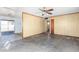 Bright living room featuring wood-paneled walls and plenty of space for personalization and design at 200 E Rose Ln, Avondale, AZ 85323