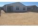 Expansive dirt backyard featuring block wall and a sliding glass door entry at 20328 N 225Th Dr, Surprise, AZ 85387