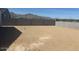 Expansive dirt backyard with concrete block perimeter wall and mountain view at 20328 N 225Th Dr, Surprise, AZ 85387